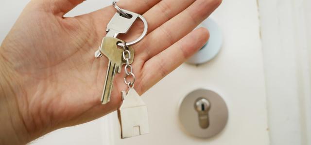 Hand holding a house key